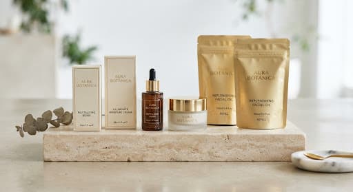 Branded cosmetic boxes, pouches and bottles on a stone display